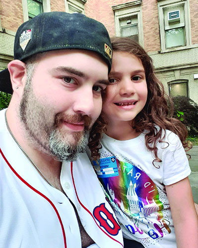 Matt and his daughter, who's sitting on his knee.